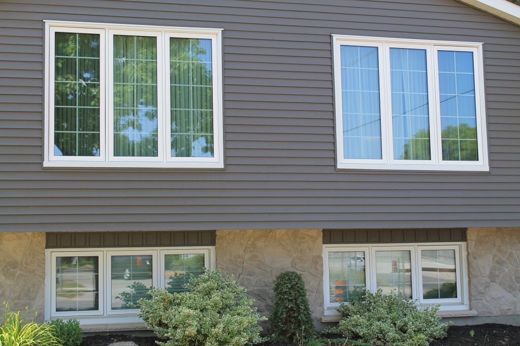 Modern energy-efficient windows installed on a home exterior with 1st Choice Home Solutions window replacements
