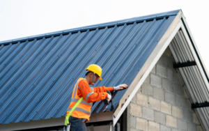 Construction worker replacing commercial roofing Ontario