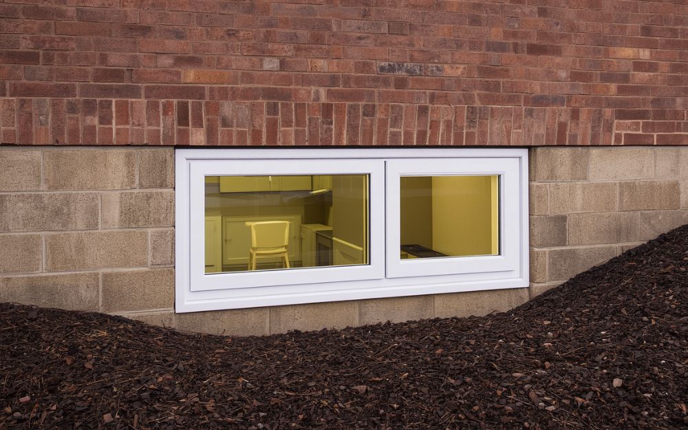 Egress window installation for a commercial or multi-unit basement suite by 1st Choice Home Solutions