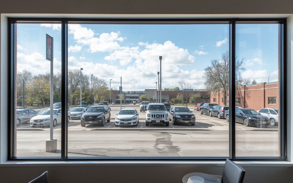 Commercial picture window installation on an office building exterior by 1st Choice Home Solutions